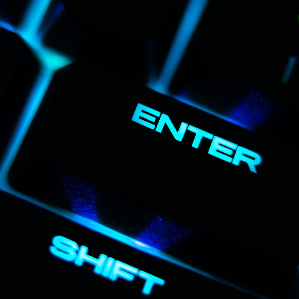 Backlit keyboard with a glowing blue 'ENTER' key.